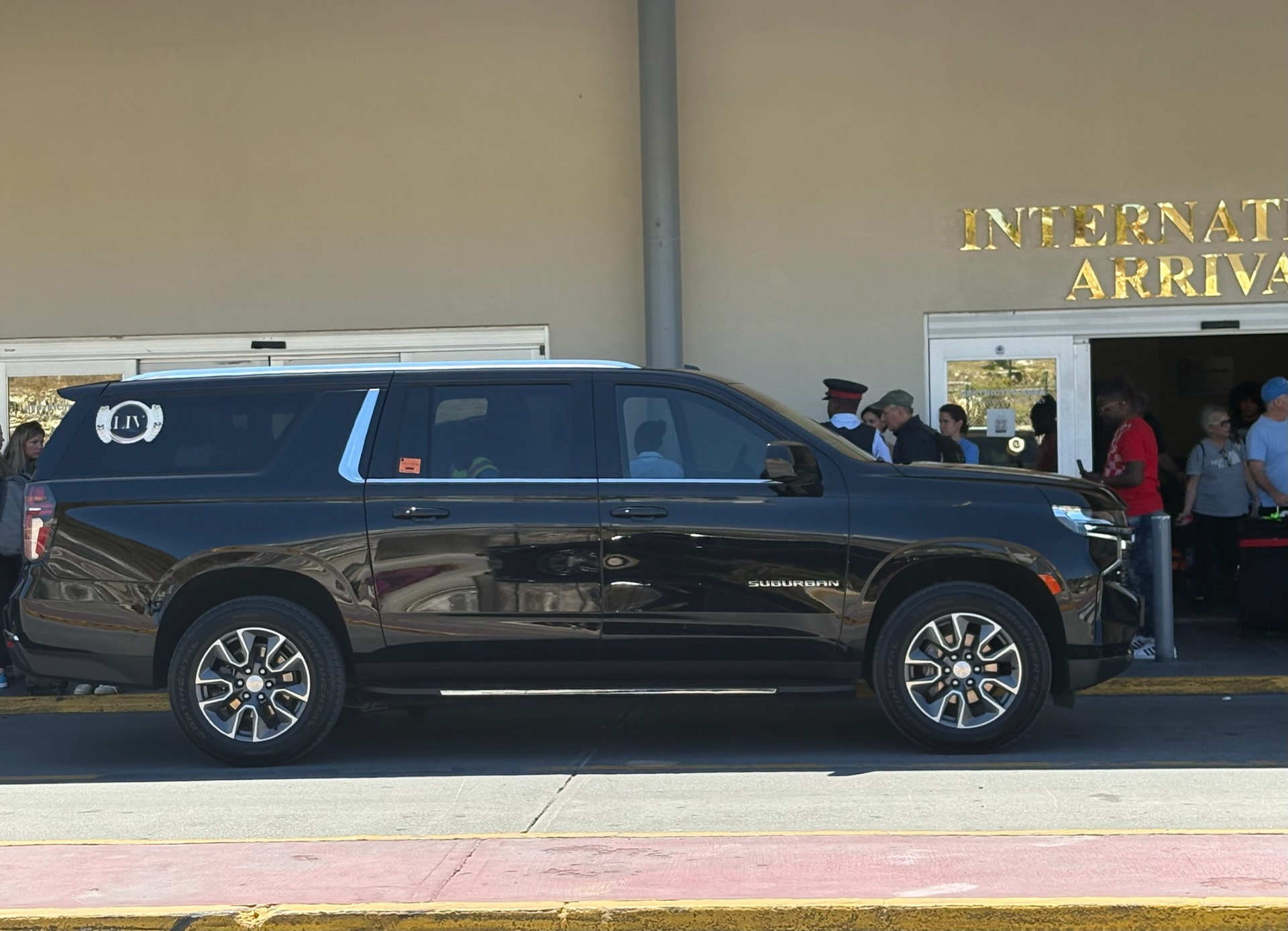 Black Suburban waiting outside PLS International Arrivals